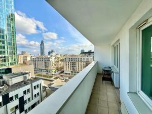 a balcony with a view of a city at Central Warsaw Apartment with Pool & Sauna in Warsaw