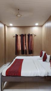 a bedroom with a large bed with wooden walls at hotel sooryoday j in Varanasi
