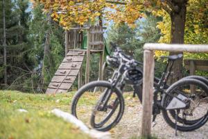 a bike parked next to a wooden fence at HOFERALPL hike-in-mountainhouse in Bagni di Lavina Bianca