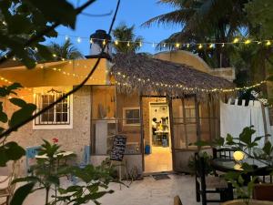 a restaurant with a sign in front of it at Beachfront Casa Maya Lodge in El Cuyo