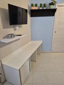 a room with a white desk with a tv on a wall at Scilla Guest House in Scilla +35 photos