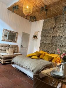 a bedroom with a bed with a yellow blanket on it at Cloître in Arles