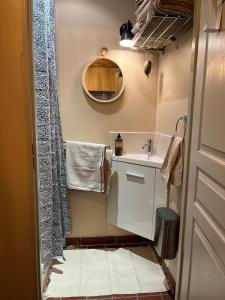 a small bathroom with a sink and a mirror at Cloître in Arles