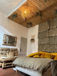 a bedroom with a bed and a chandelier at Cloître in Arles