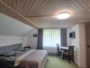 a bedroom with a bed and a table with chairs at Hollywood in Yaremche +55 photos
