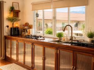 a kitchen with a sink and a window at Pai Local Apartment in Pai