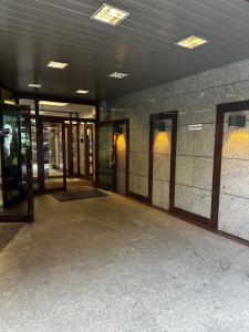 an empty lobby of a building with glass doors at Central Warsaw Apartment with Pool & Sauna in Warsaw