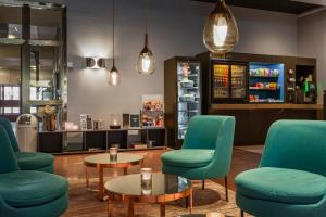 a waiting room with blue chairs and a table at Quality Hotel Sundsvall in Sundsvall +47 photos