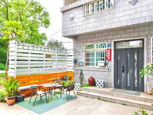 a patio with a table and chairs in front of a building at Kinmen Harved B&B in Jinhu
