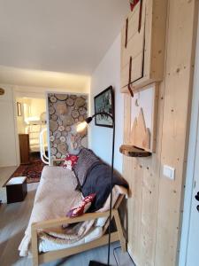 a room with a bed with a lamp in it at La Tanière in Ustou