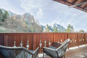 two chairs on a deck with mountains in the background at HOFERALPL hike-in-mountainhouse in Bagni di Lavina Bianca