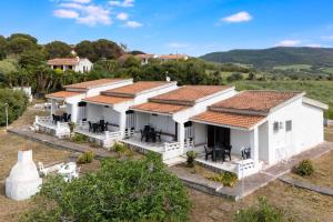 an aerial view of a white house with red roof at Villa Rosa Sea View in Valledoria