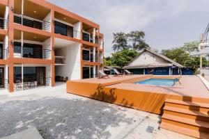 an external view of a building with a swimming pool at Sinai Rimtalay Hotel in Ban Nong Sanom