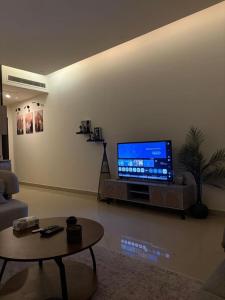 a living room with a flat screen tv on a wall at ڤيا Via in Buraydah