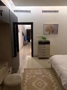 a bedroom with a bed and a dresser and a mirror at ڤيا Via in Buraydah +14 photos