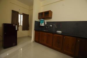 a kitchen with a sink and a bath tub at Classique Inn Near Padmanabhaswamy Temple in Trivandrum