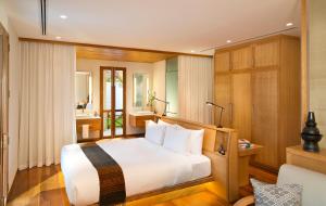 a bedroom with a large white bed and a bathroom at Avani+ Luang Prabang Hotel in Luang Prabang +78 photos