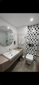 a bathroom with a sink and a toilet at Hotel Buyuk Sahinler in Istanbul