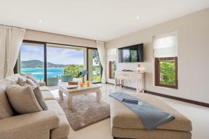 a living room with a couch and a table at Oceans Eleven Villa Samui - Oceanfront, Private Pool, Perfect for families and friends in Bangrak Beach