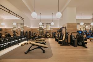 a gym with lots of treadmills and weights at Six Senses London in London +33 photos