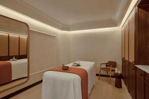 a hotel room with a table and a mirror at Six Senses London in London