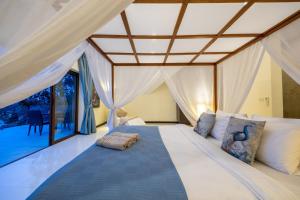 a bedroom with a bed with a large window at Oceans Eleven Villa Samui - Oceanfront, Private Pool, Perfect for families and friends in Bangrak Beach +38 photos