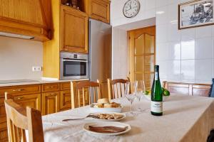 a kitchen with a table with a bottle of wine at Kai in Getaria