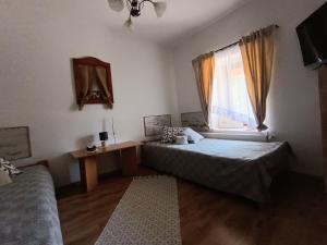 a bedroom with two beds and a window at Tisza-tavi Menedék in Poroszló