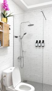 a bathroom with a shower and a toilet in it at SARALIS Home in Abidjan