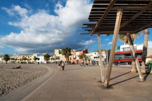 a group of people walking on the beach at BluehousePortixol Mallorca in Palma de Mallorca