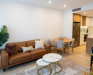 a living room with a couch and a table at Stylish 1BR Getaway and Option for 2nd Br in Campbell