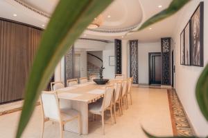 a dining room with a long table and chairs at Full Moon Guesthouse in Dubai