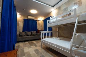 a room with two bunk beds and a couch at IT Farm Resort in Rizal