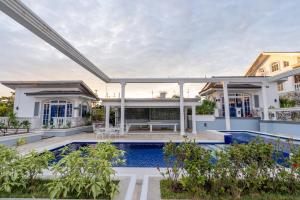 an exterior view of a house with a swimming pool at IT Farm Resort in Rizal