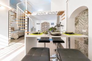 a kitchen with a counter and stools in a room at Venti Nodi in Vieste