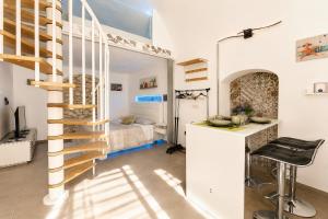 a spiral staircase in a room with a bedroom at Venti Nodi in Vieste +24 photos