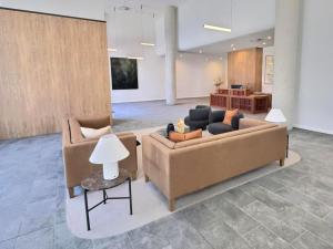 a living room with two couches and a table at Stylish 1BR Getaway and Option for 2nd Br in Campbell
