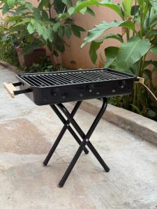 a barbecue grill sitting on top of a sidewalk at Clean Culture Retreat in Mysore