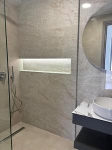 a bathroom with a sink and a mirror at Coralli Beachfront in Pefki +15 photos