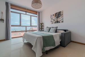 a bedroom with a bed and a large window at El Balcon de Moaña in Moaña