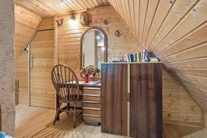 an attic room with a desk and a chair at Fairy Tale House in Trenta