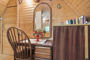a table with a mirror and two chairs in a room at Fairy Tale House in Trenta