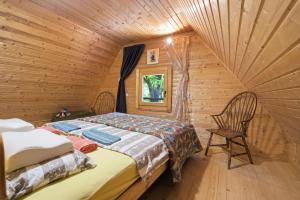 a bedroom with a bed in a log cabin at Fairy Tale House in Trenta
