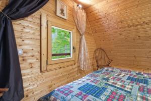 a bedroom with a bed in a log cabin at Fairy Tale House in Trenta