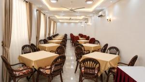 a row of tables and chairs in a restaurant at Prestige Leisure Hotel in Mtwapa