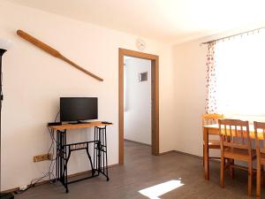 a room with a desk with a television on a table at Apartmán Dvojka in Benecko