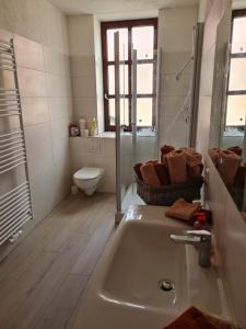 a bathroom with a sink and a toilet at Große Ferienwohnung 160qm in einzigartigem historischen 700 Jahre altem Gebäude in Hardegsen +37 photos