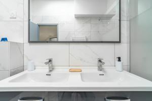a bathroom with a white sink and a mirror at Secret Garden in Vias