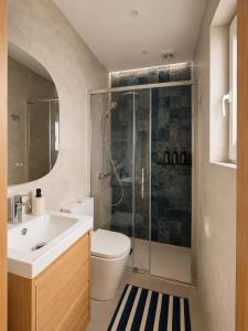 a bathroom with a shower and a toilet and a sink at Blue Bay in Lagos +8 photos