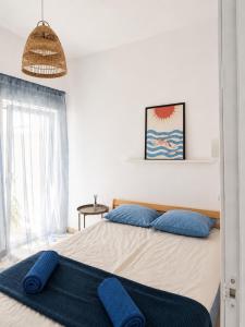 a bedroom with a large bed with blue pillows at Blue Bay in Lagos
